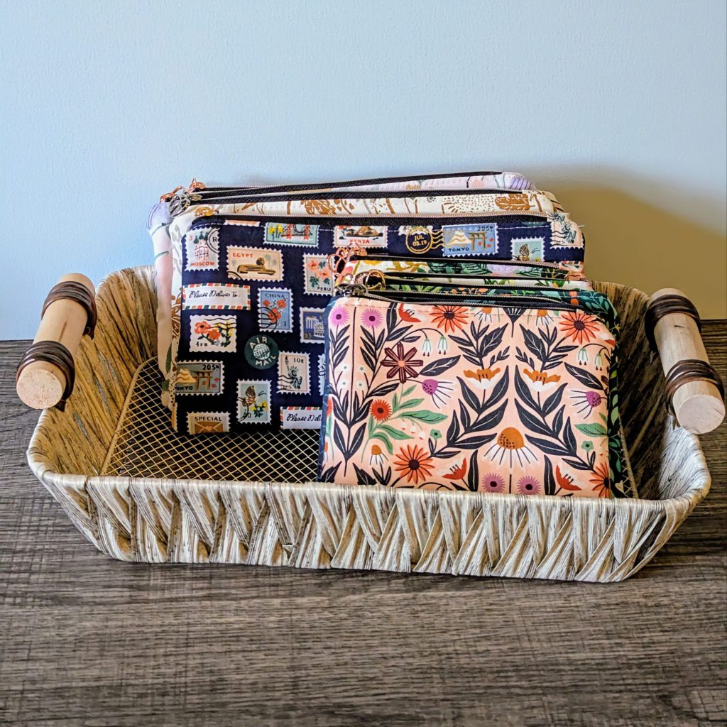 Basket with variety of cotton zipper pouches in two sizes.